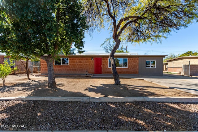 single story home featuring brick siding and fence