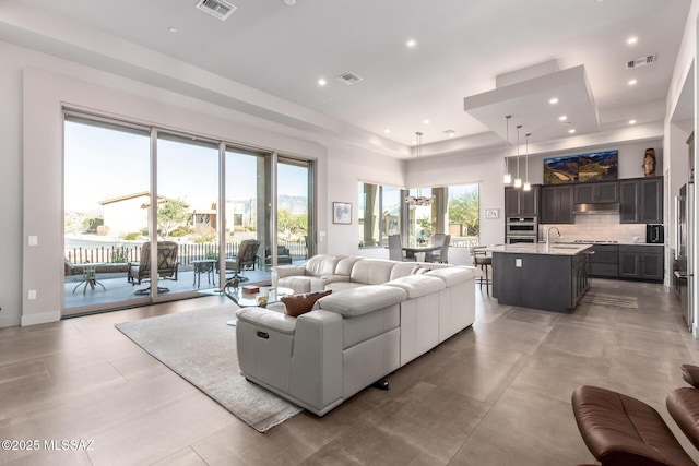 living area with visible vents and recessed lighting