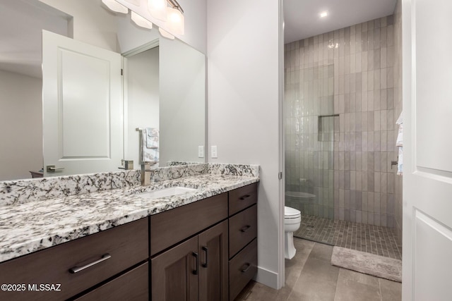 full bath with a stall shower, tile patterned flooring, vanity, and toilet