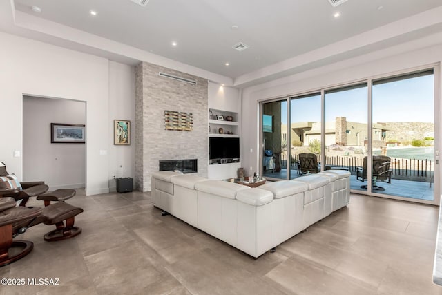 living area featuring built in shelves, a fireplace, recessed lighting, and baseboards