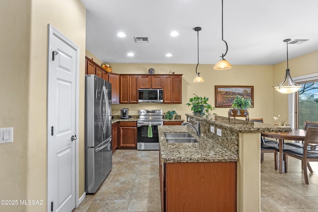 kitchen featuring a center island with sink, visible vents, dark stone countertops, stainless steel appliances, and a sink