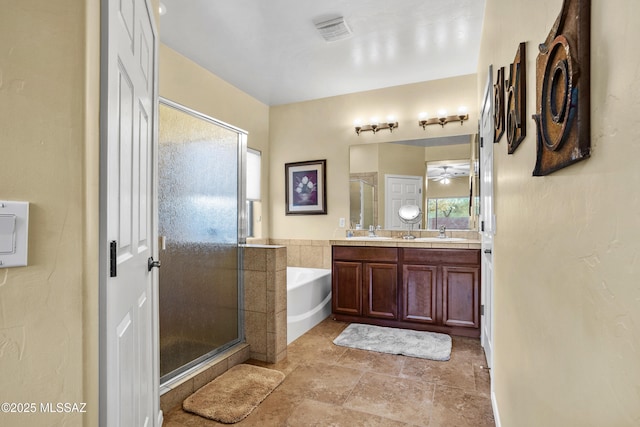 bathroom with a stall shower, visible vents, vanity, and a bath