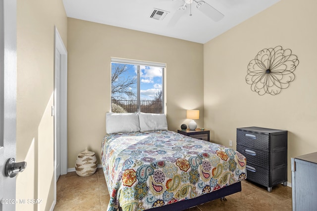 tiled bedroom with baseboards, visible vents, and ceiling fan