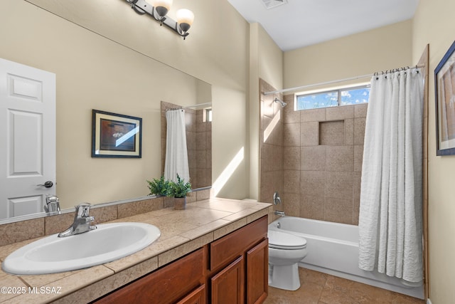 full bath with visible vents, toilet, vanity, and shower / tub combo with curtain