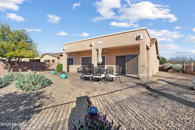 rear view of property with a patio area, a fenced backyard, and stucco siding