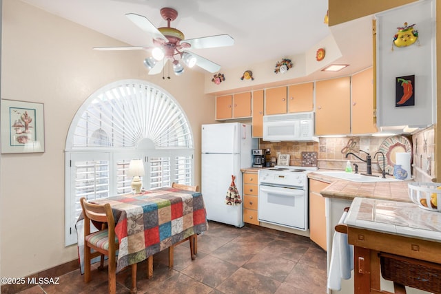 kitchen with white appliances, tasteful backsplash, a ceiling fan, tile countertops, and a sink