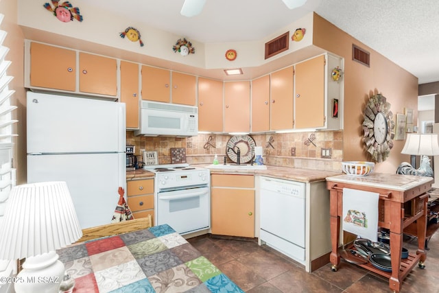 kitchen with light countertops, white appliances, visible vents, and backsplash