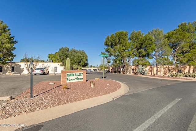 view of road with traffic signs and curbs