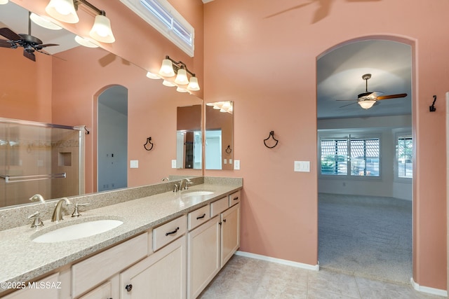 bathroom featuring double vanity, ceiling fan, and a sink