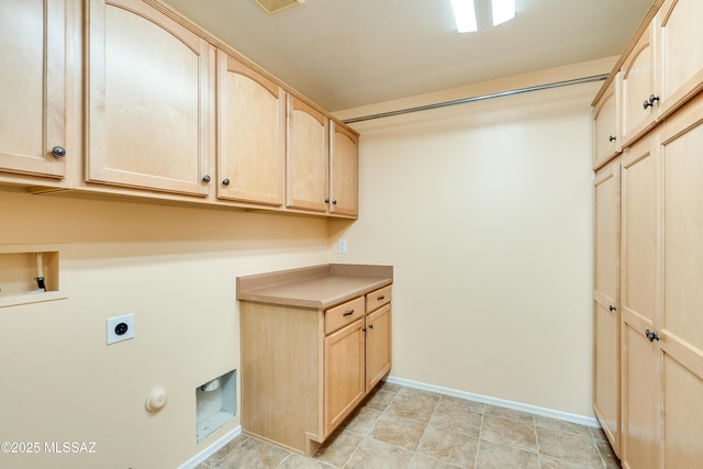 laundry area featuring baseboards, hookup for a washing machine, cabinet space, and electric dryer hookup