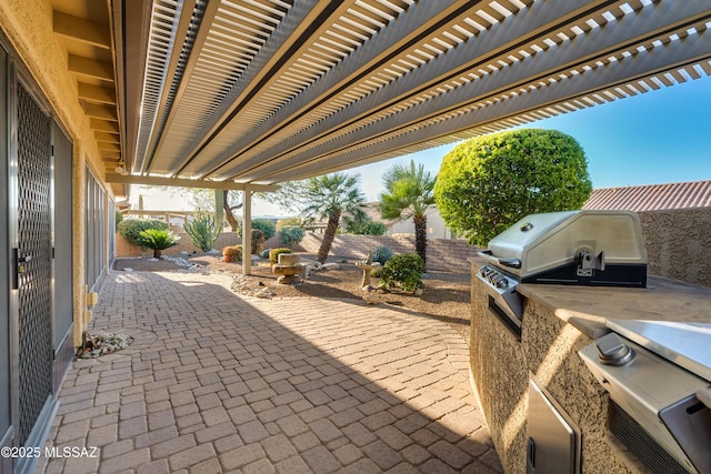 view of patio with area for grilling, a fenced backyard, and a pergola