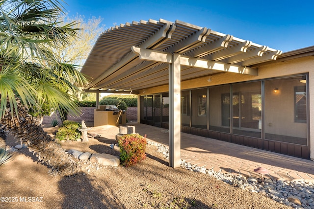 view of patio / terrace featuring exterior kitchen and a pergola