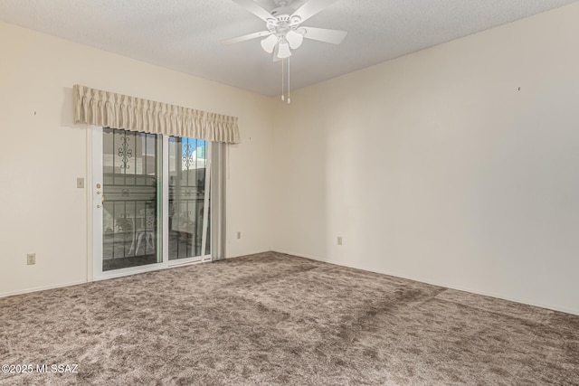 carpeted empty room with a textured ceiling and a ceiling fan