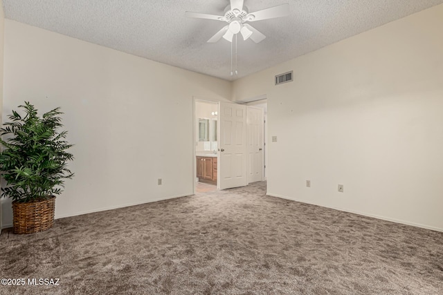 unfurnished room featuring baseboards, visible vents, light colored carpet, ceiling fan, and a textured ceiling