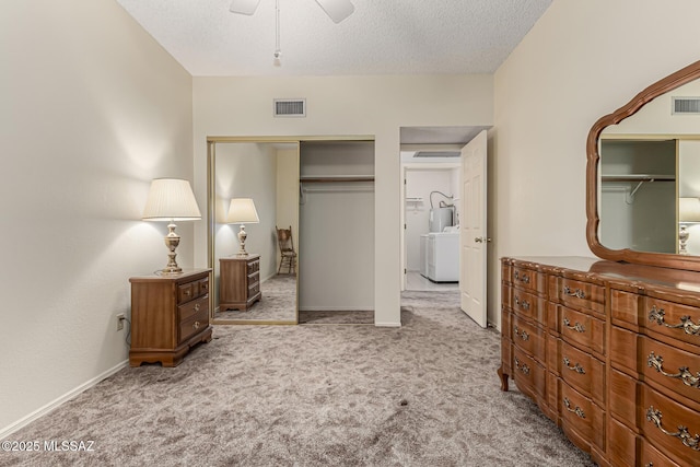 carpeted bedroom featuring a textured ceiling, a closet, visible vents, and baseboards