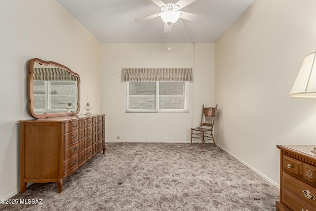 carpeted bedroom with a textured ceiling, ceiling fan, and baseboards