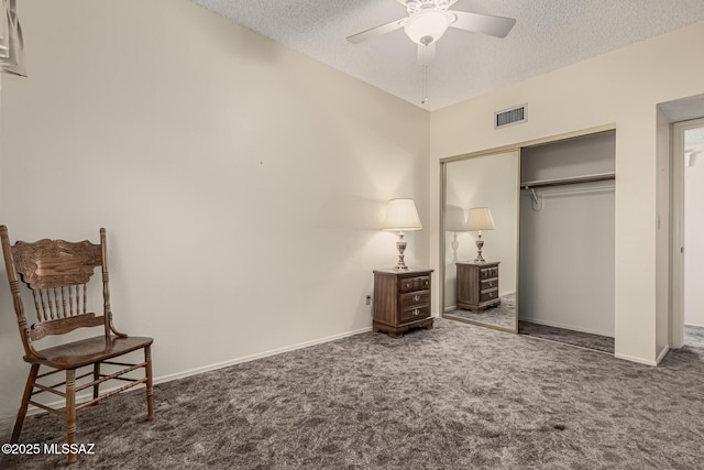 carpeted bedroom featuring a textured ceiling, a closet, visible vents, and baseboards