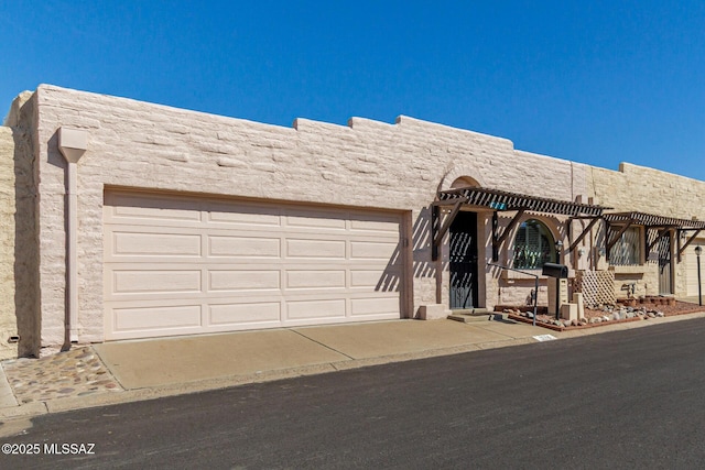 pueblo-style house featuring a pergola