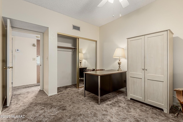 office with a ceiling fan, carpet, visible vents, and a textured ceiling