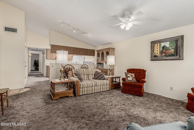 carpeted living room with a ceiling fan, visible vents, high vaulted ceiling, and a textured ceiling