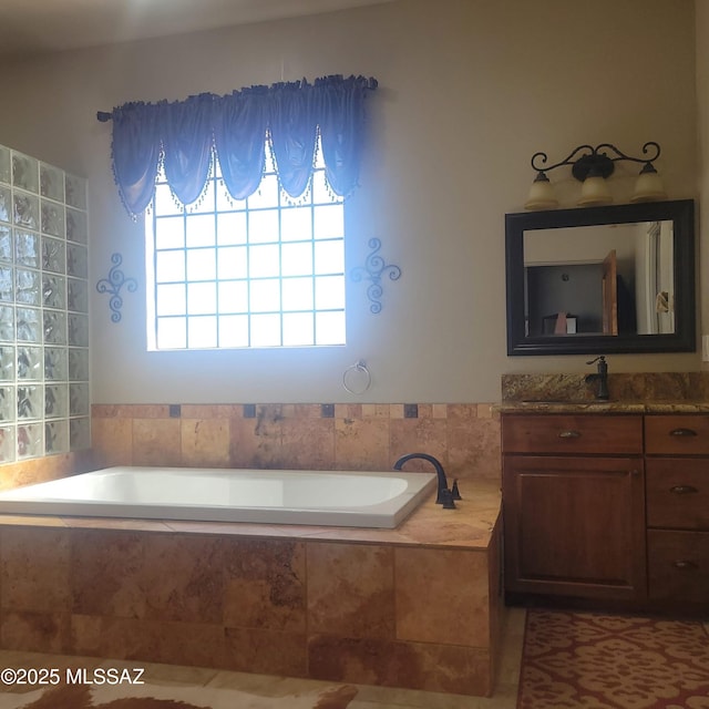 bathroom with vanity and a bath