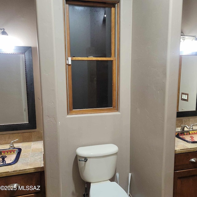 bathroom with toilet and vanity