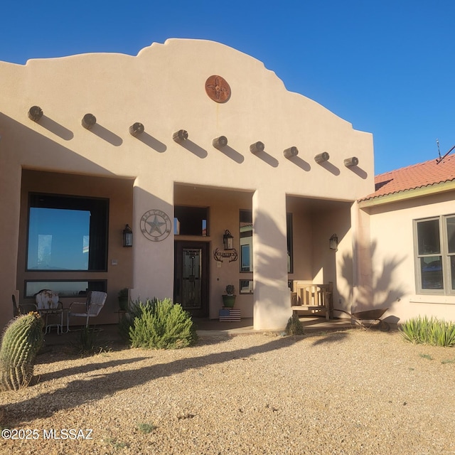 adobe home featuring stucco siding