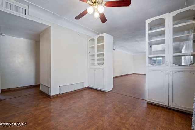 unfurnished room featuring wood finished floors, visible vents, and ceiling fan