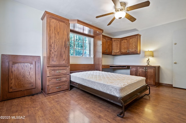 bedroom featuring a ceiling fan and wood finished floors