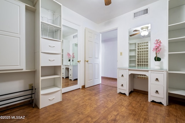 interior space featuring visible vents, wood finished floors, and a ceiling fan