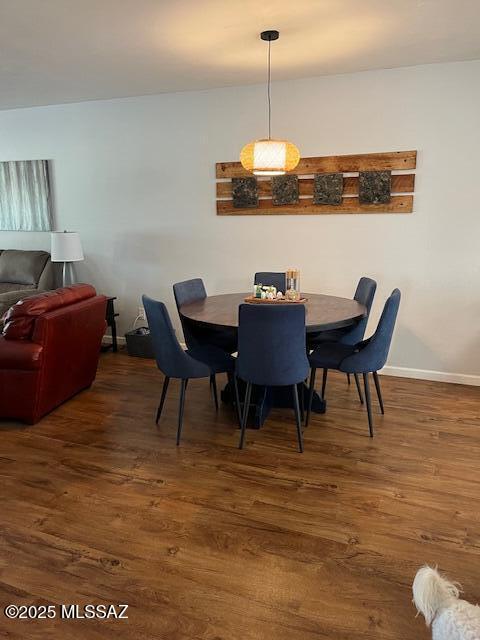 dining room featuring baseboards and wood finished floors