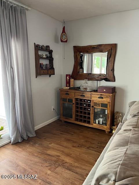 interior space featuring baseboards and wood finished floors