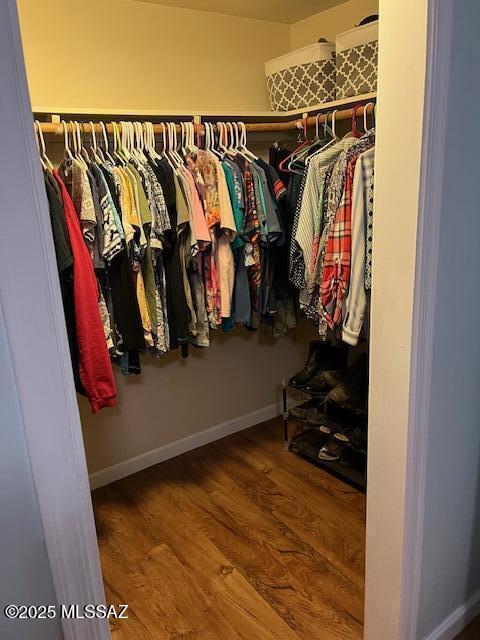 spacious closet with wood finished floors