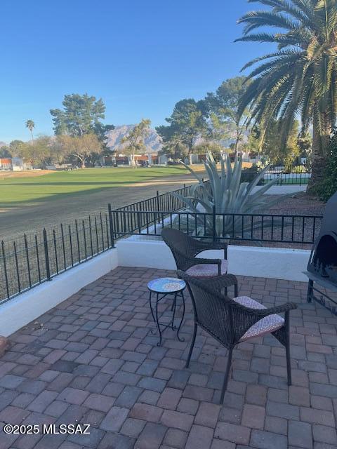 view of patio featuring fence