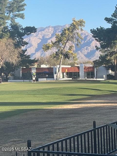 view of community with a yard and a mountain view