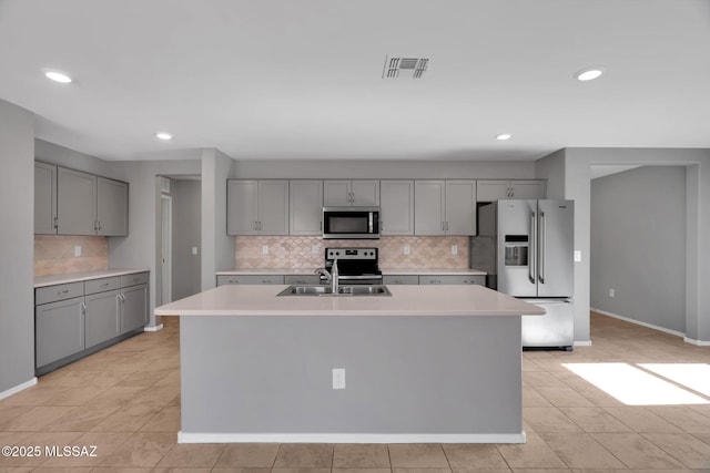 14241 E Bolster Dr, Vail, AZ 85641 - kitchen with appliances with stainless steel finishes, gray cabinetry, tasteful backsplash, light countertops, and light tile patterned floors