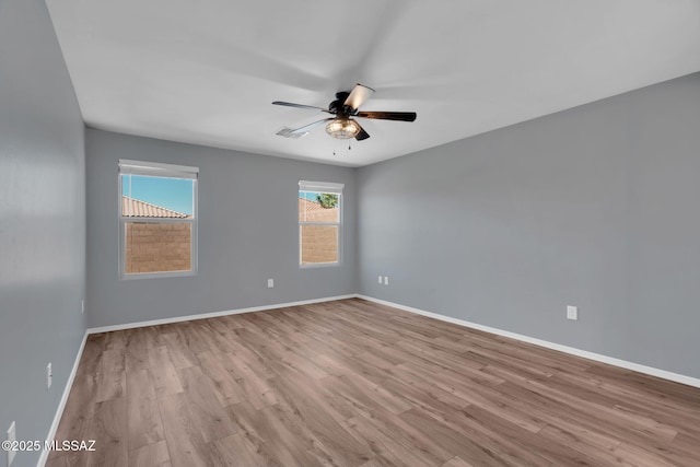 14241 E Bolster Dr, Vail, AZ 85641 - empty room with a ceiling fan, wood finished floors, and baseboards