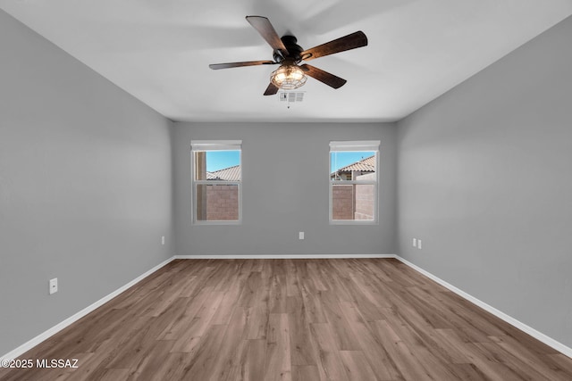 14241 E Bolster Dr, Vail, AZ 85641 - spare room featuring healthy amount of natural light, wood finished floors, a ceiling fan, and baseboards