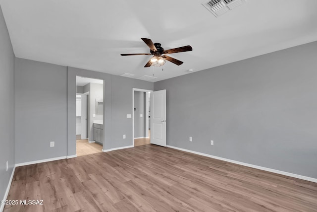 14241 E Bolster Dr, Vail, AZ 85641 - unfurnished bedroom with light wood-style floors, baseboards, ensuite bath, and ceiling fan