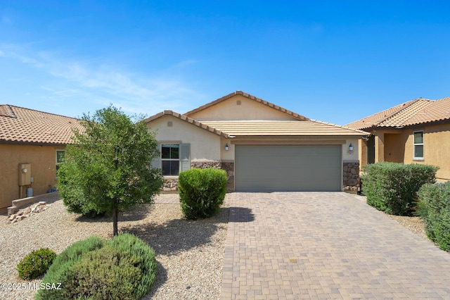 14241 E Bolster Dr, Vail, AZ 85641 - view of front of house featuring stone siding, a garage, stucco siding, driveway, and a tiled roof