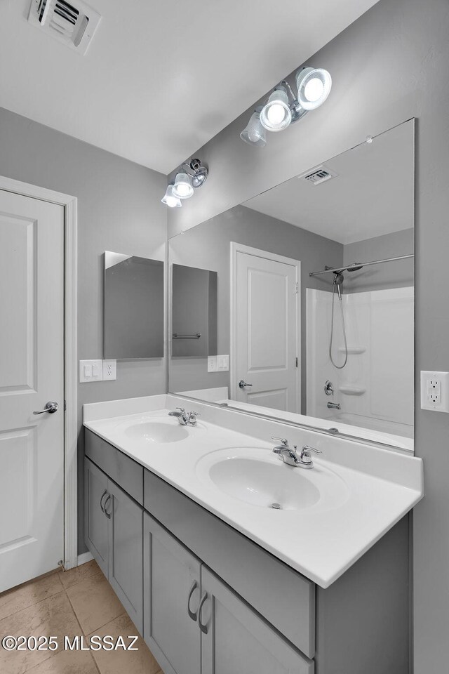 14241 E Bolster Dr, Vail, AZ 85641 - bathroom featuring double vanity, tile patterned flooring, and a shower