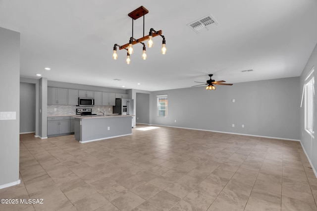14241 E Bolster Dr, Vail, AZ 85641 - unfurnished living room featuring a ceiling fan, recessed lighting, a sink, and baseboards