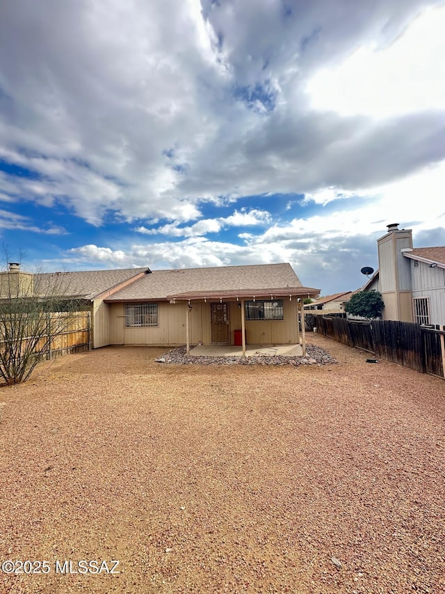 rear view of property with a patio area and a fenced backyard