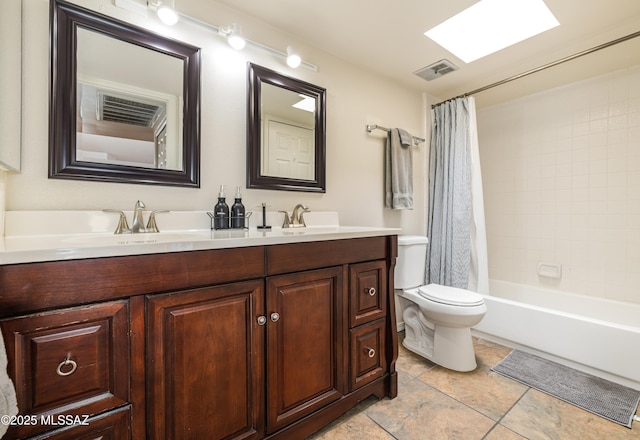 bathroom with a sink, visible vents, toilet, and double vanity