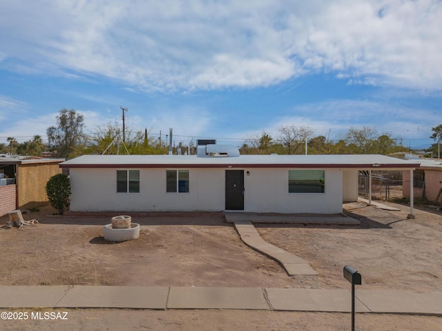 ranch-style home featuring fence