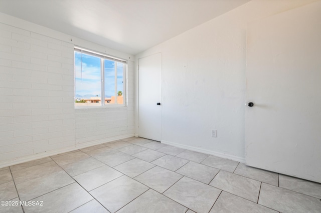 unfurnished room with light tile patterned flooring