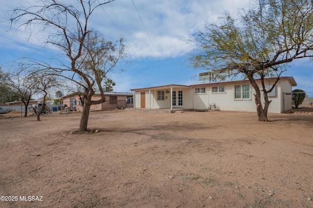 rear view of property with french doors