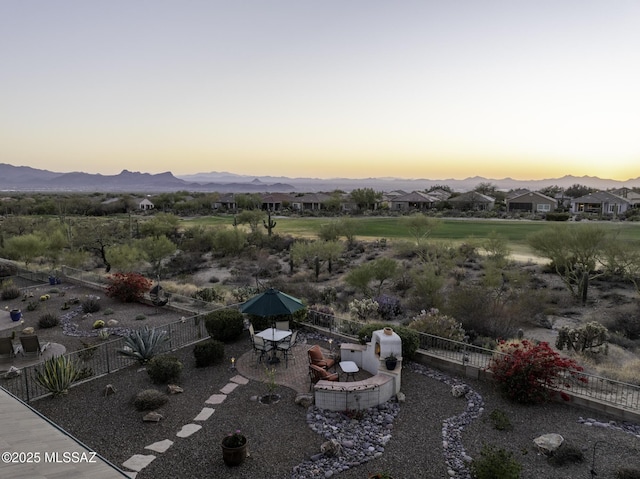 aerial view at dusk featuring a mountain view