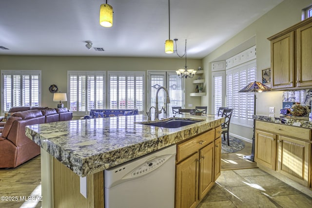 13517 N Heritage Gateway Ave, Marana, AZ 85658 - kitchen featuring a notable chandelier, a center island with sink, a sink, white dishwasher, and hanging light fixtures