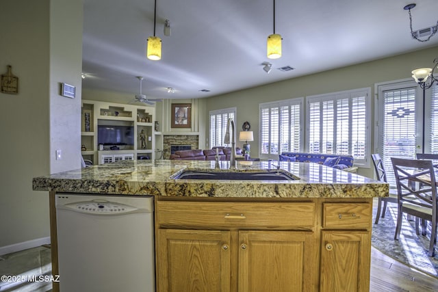 13517 N Heritage Gateway Ave, Marana, AZ 85658 - kitchen with open floor plan, dishwasher, a fireplace, a ceiling fan, and a sink